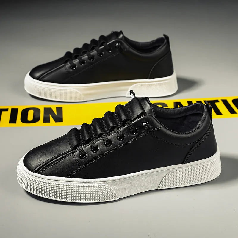 Men's black and white low top synthetic leather sports shoes with mesh panels and a PVC sole.
