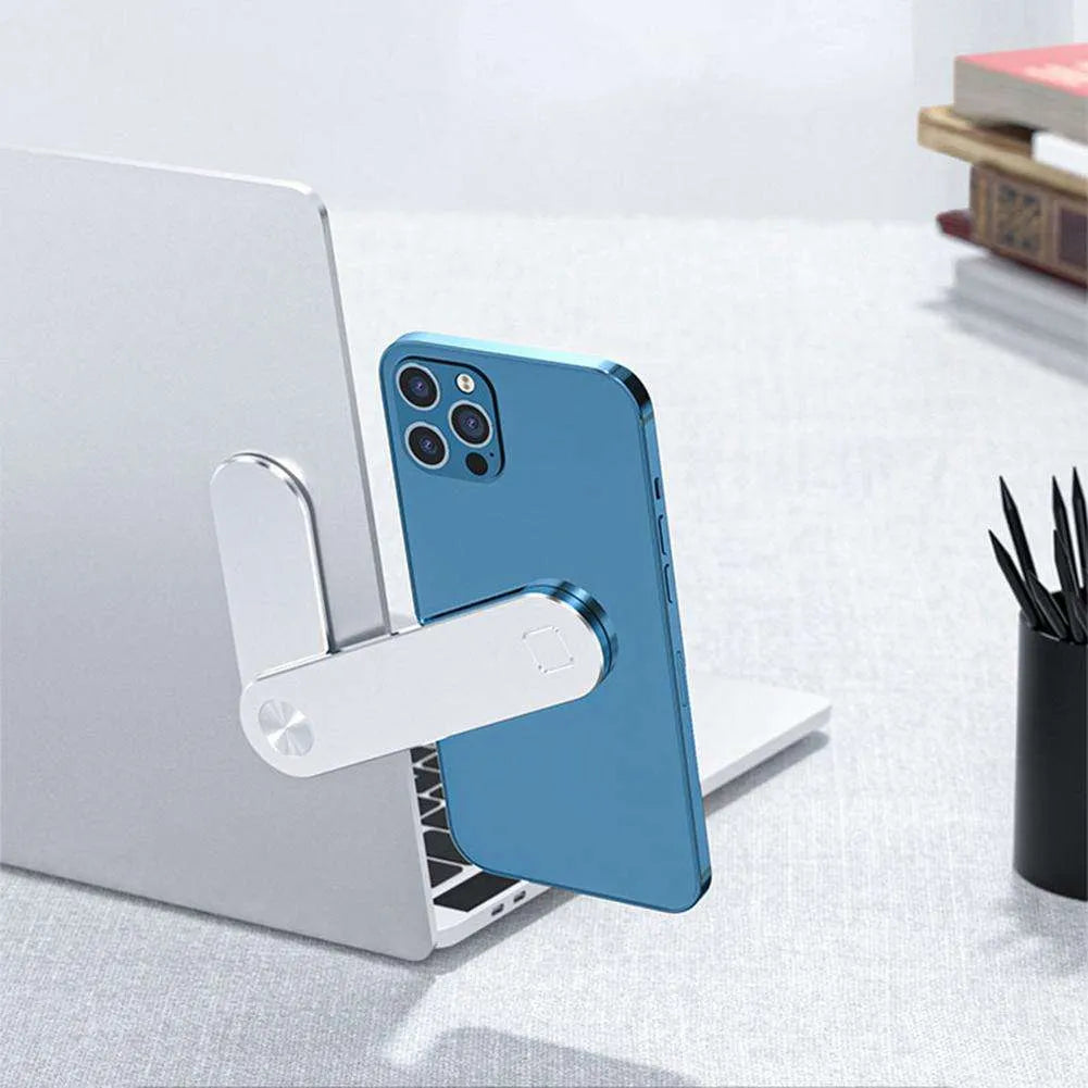 Black aluminium laptop phone holder with magnetic mount attached to side of silver laptop