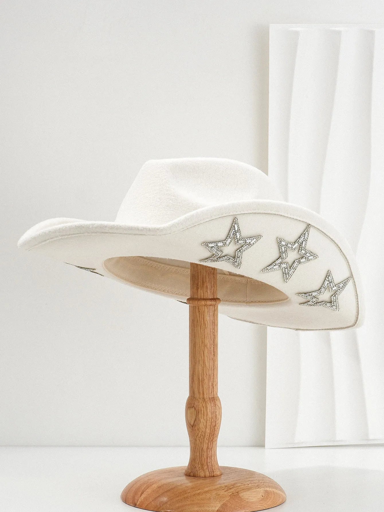 Beige wool felt western cowboy hat with a hexagonal star on the side, conical crown.