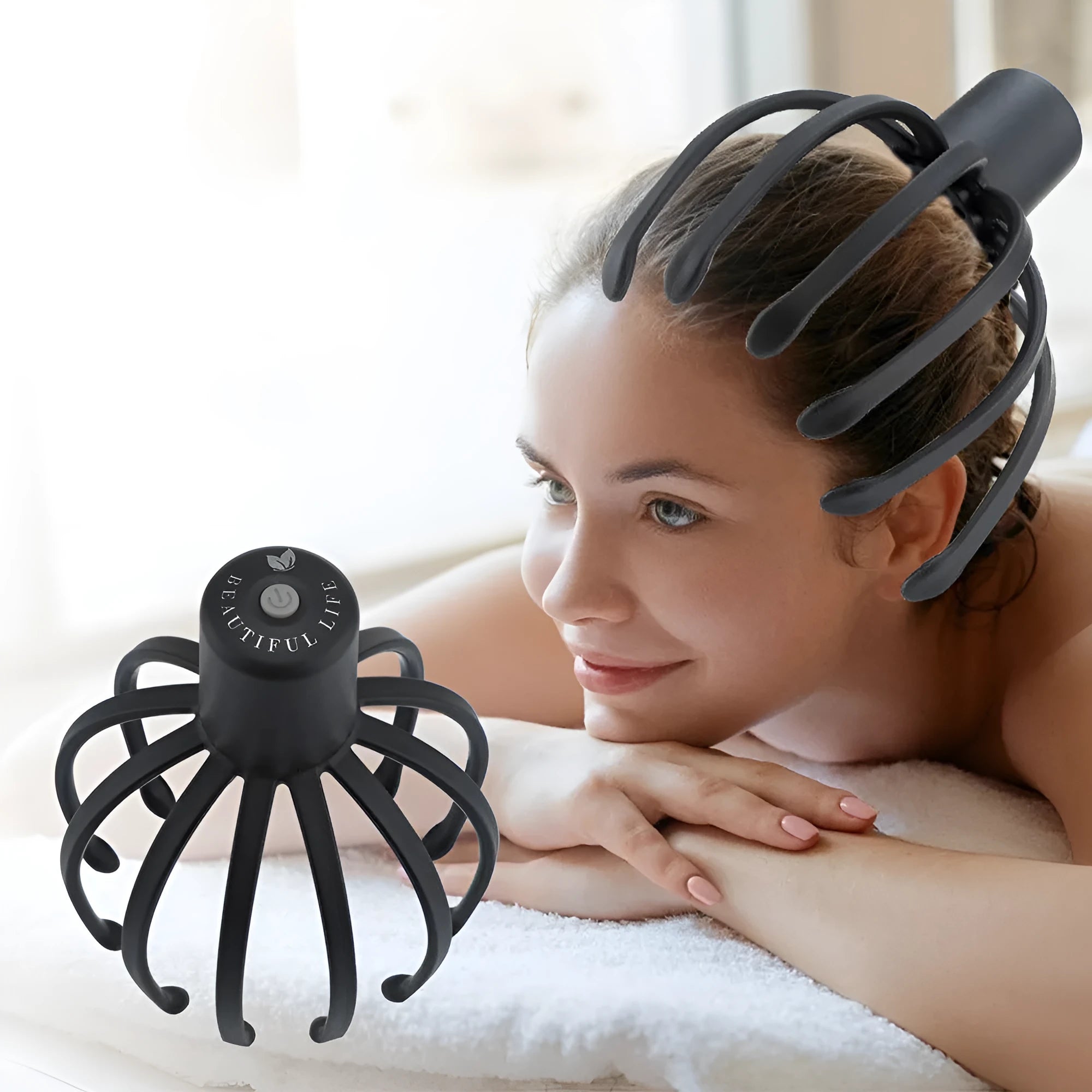 Black electric scalp massager with 12 TPE 3D massage arms on a flat surface