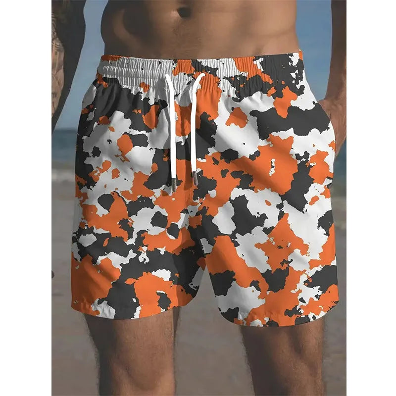 Man wearing coloured print polyester beach shorts with an elastic waistband for summer travel.