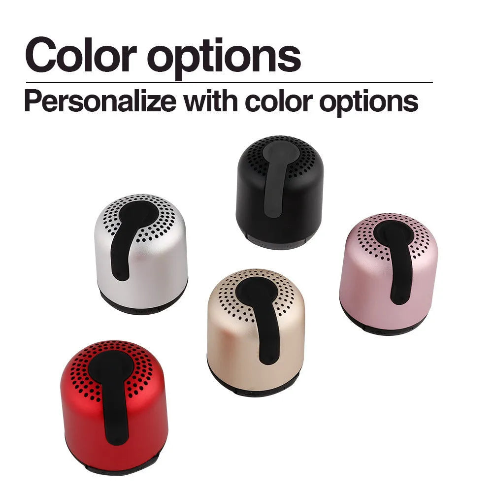 Hieha XQ11 cylindrical portable Bluetooth speaker in silver colour on a table.