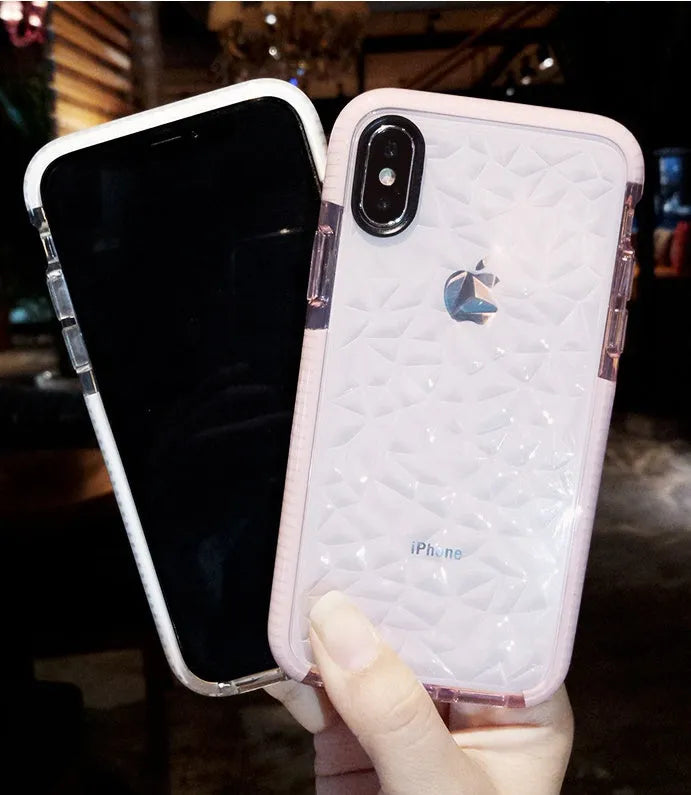 Striped TPU iPhone case shown in black, pink, and white edge colour options on a table.