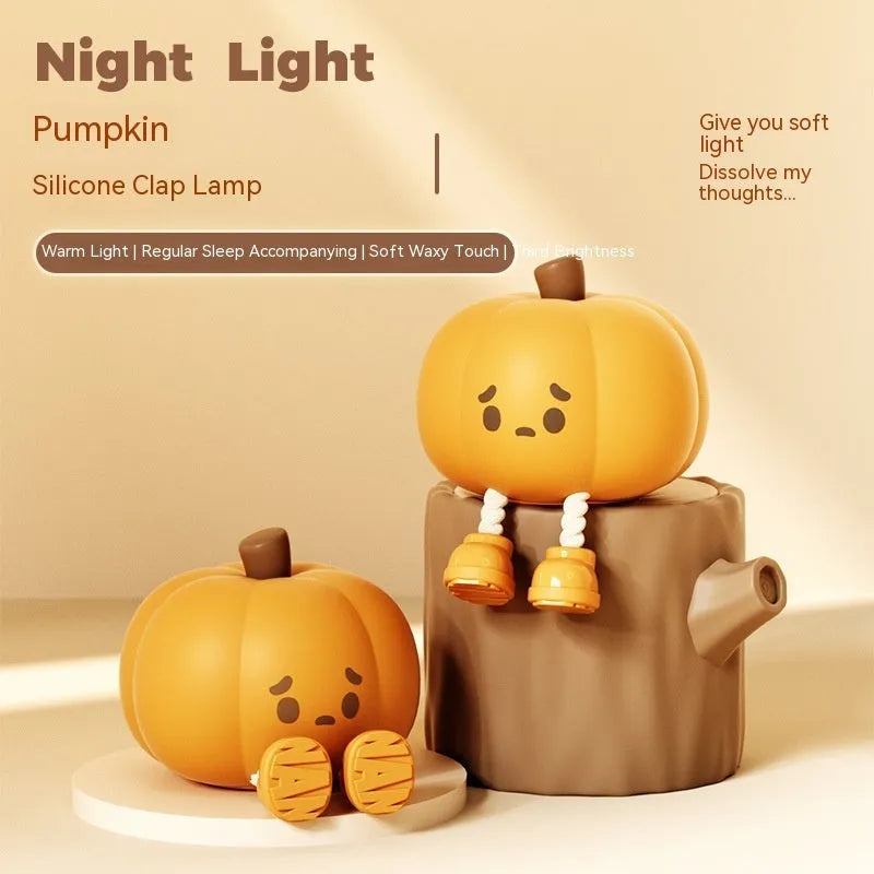 Soft orange silicone pumpkin-shaped night light with a gentle glow, sitting on a surface.