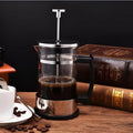 Compact stovetop coffee maker with glass chamber and stainless steel base, showing 350ml capacity.