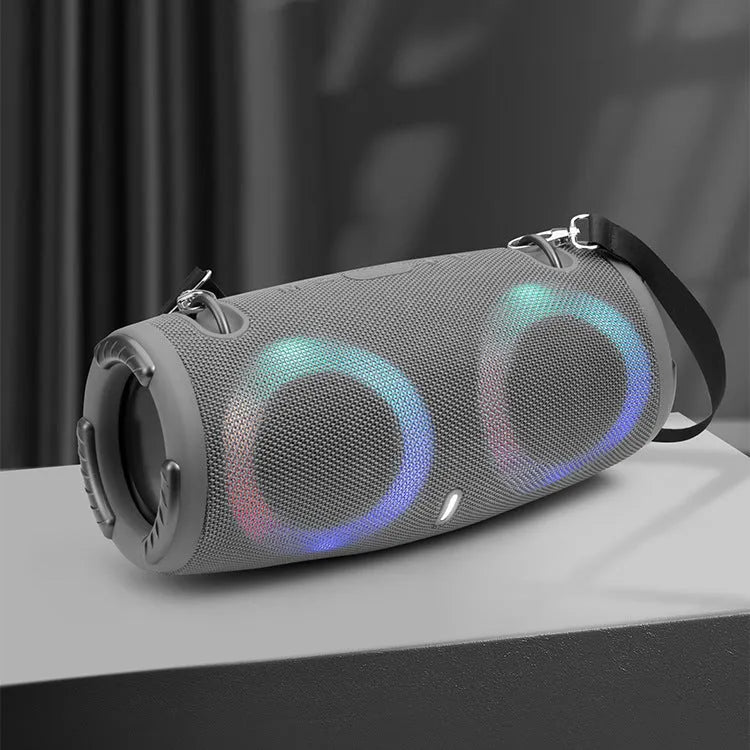 War Drum portable Bluetooth speaker with multi-colour RGB lights, showing carry strap and waterproof casing.
