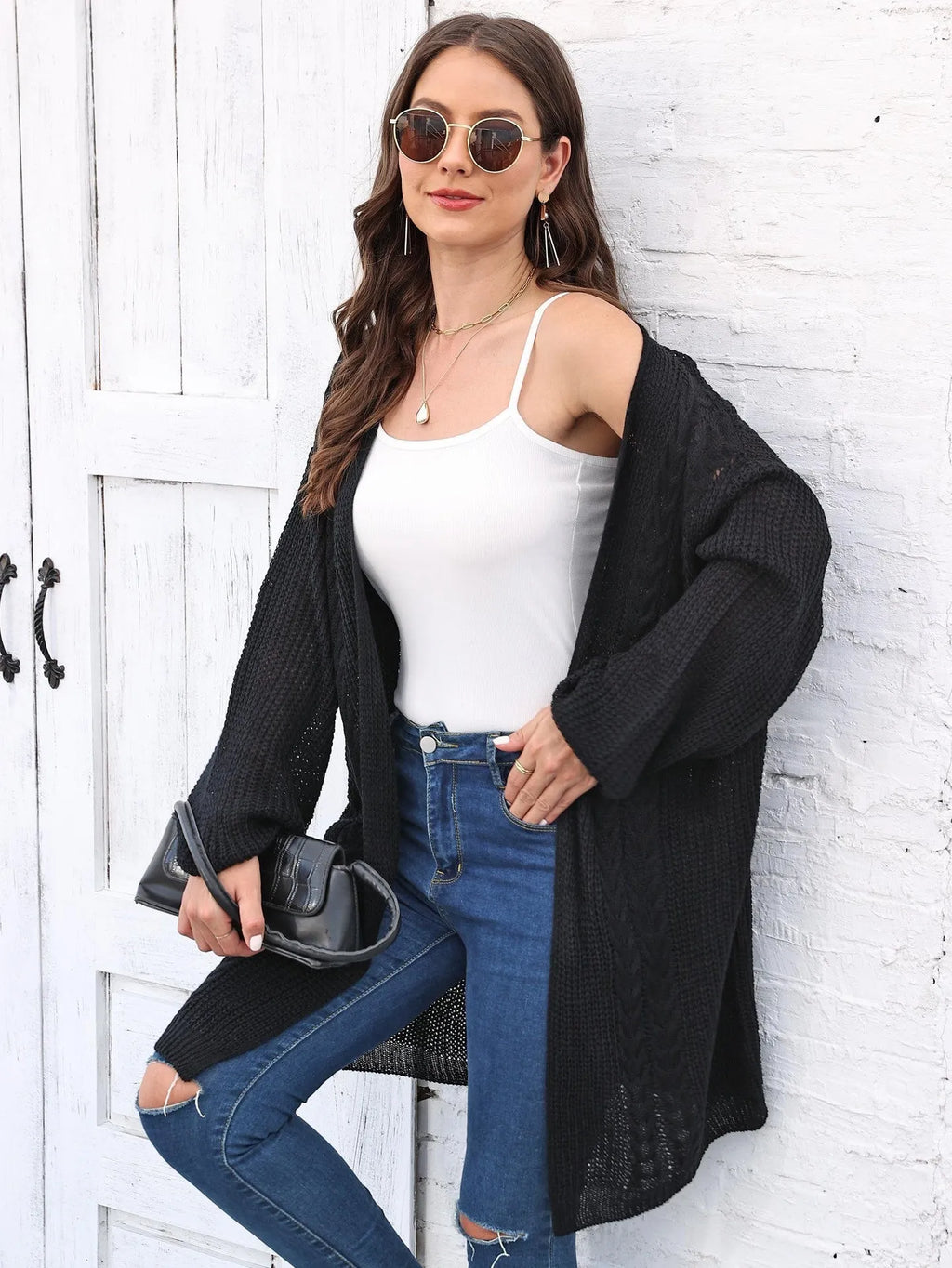 Women's loose longline acrylic cardigan sweater coat in a solid colour.