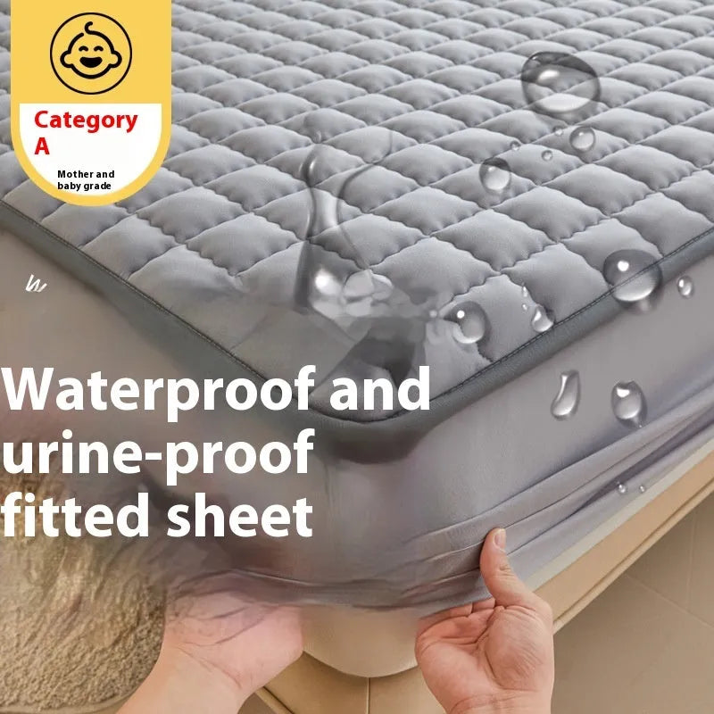 Class A waterproof fitted sheet in washed cotton, shown in a neutral colour on a bed.