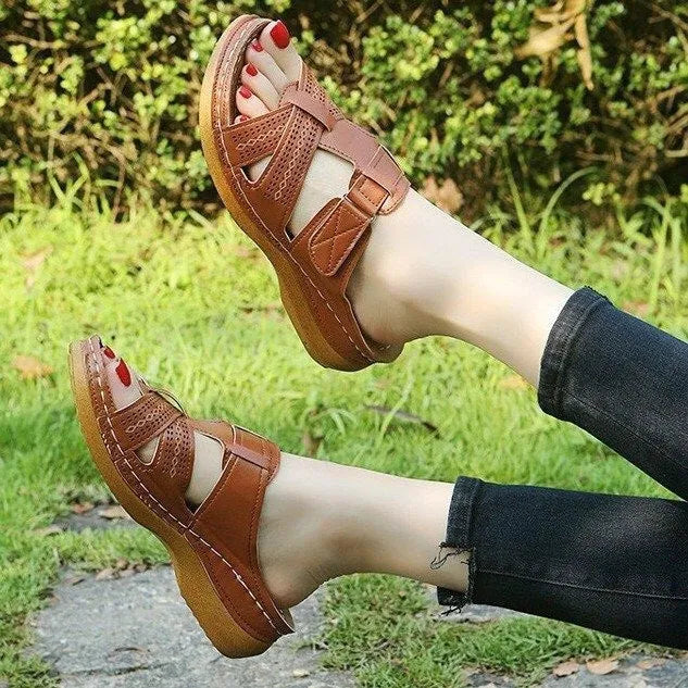 Women's red peep toe wedge sandals with Velcro strap on a fish mouth sole.