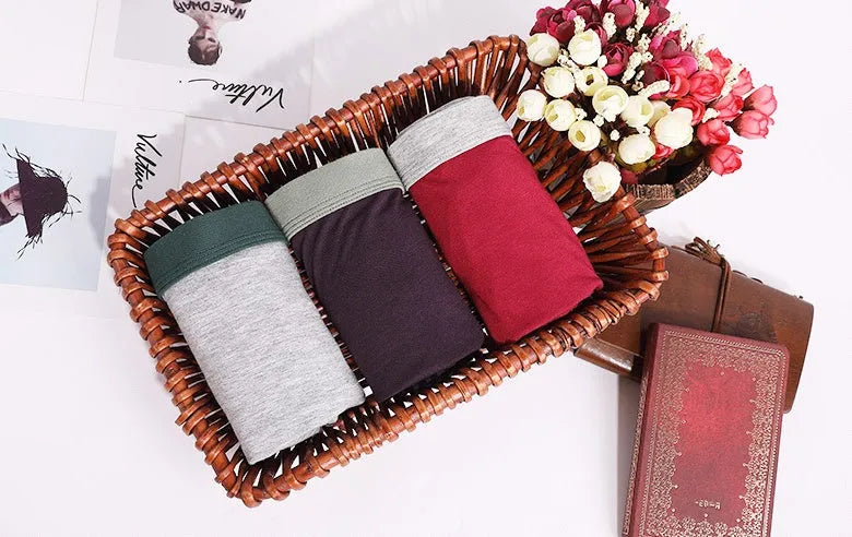 Men's oversized cotton baggy boxers in black, red, gray, blue and purple on a white background