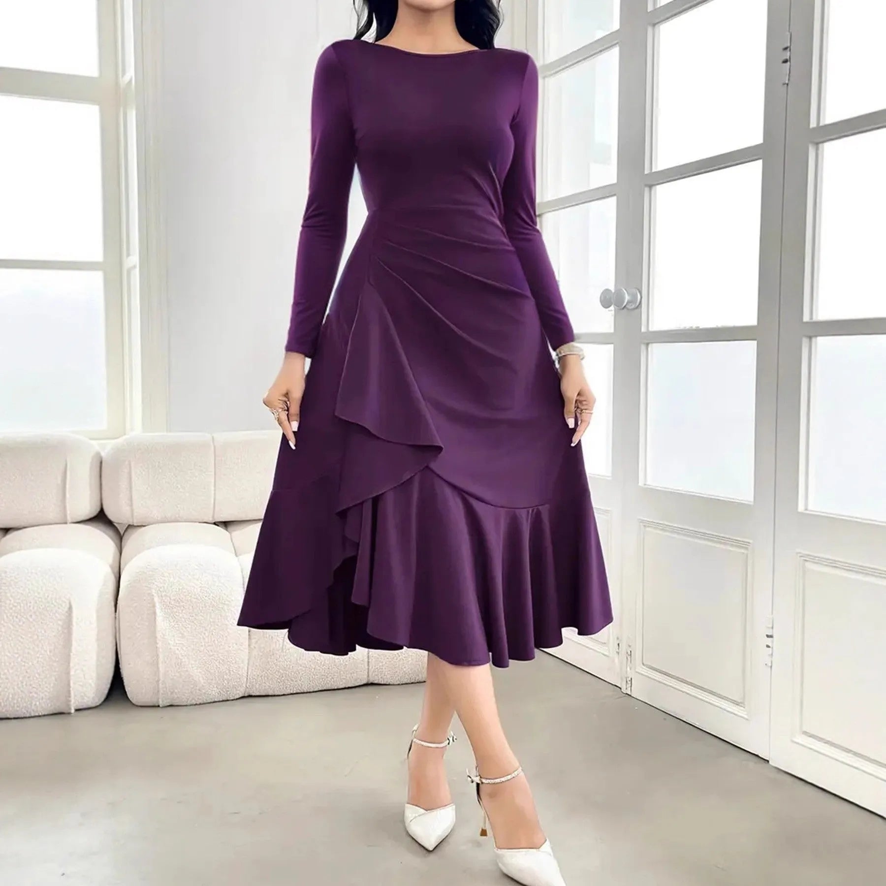 Purple women's long sleeve dress with ruffle detail and a round neck, shown on a model.