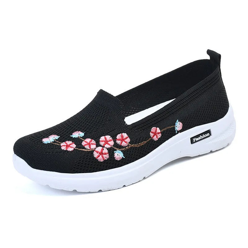 Women's black woven ballet pumps with floral embroidery and a flat anti-slip sole.