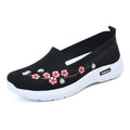 Women's black woven ballet pumps with floral embroidery and a flat anti-slip sole.
