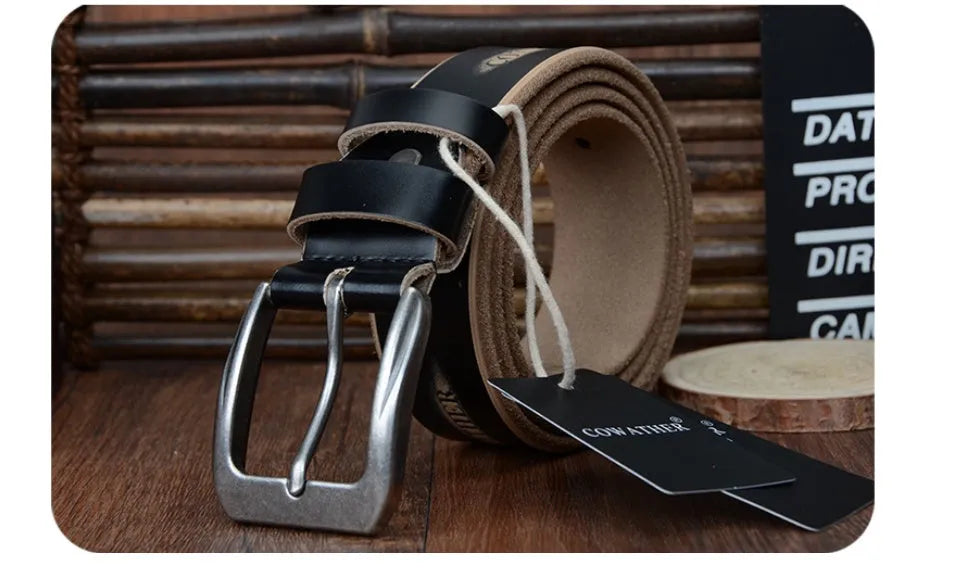 Men's leather belt in black with square alloy buckle on a dark background
