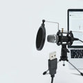 Black condenser microphone on stand with 3.5mm and USB cables for mobile and computer recording
