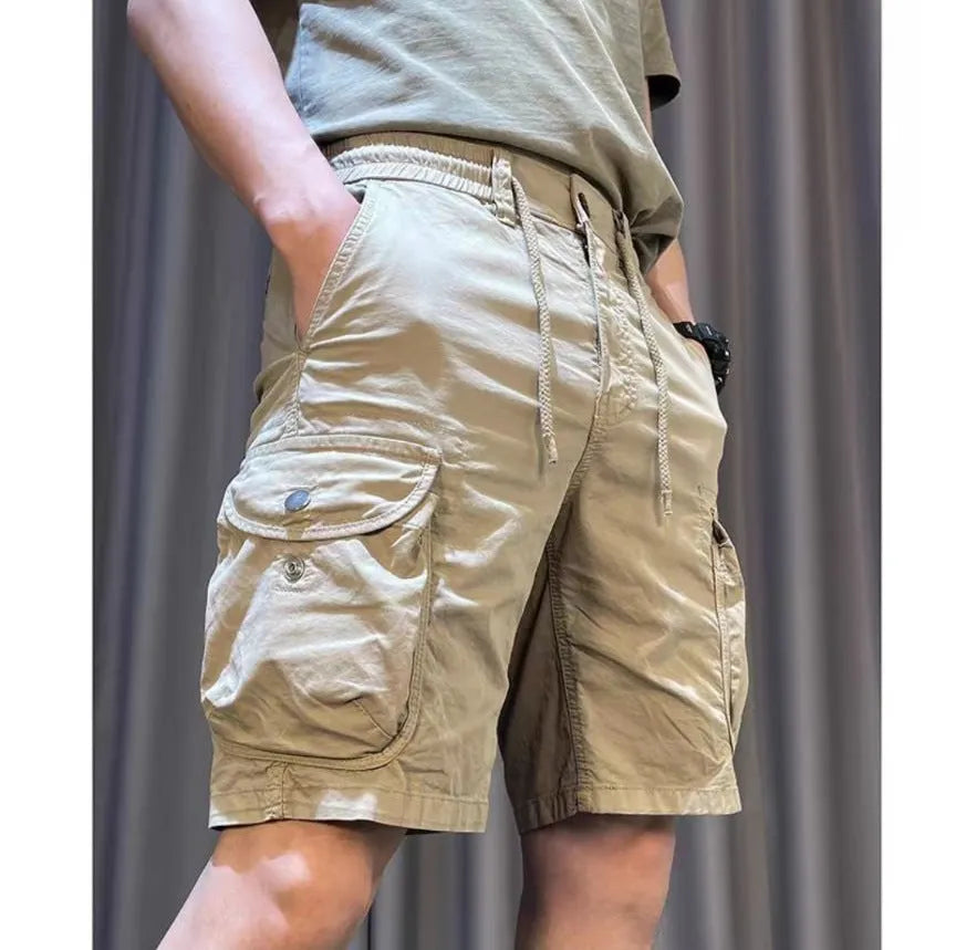 Loose straight-leg Korean-style casual overalls in khaki with multiple pockets on a neutral background.