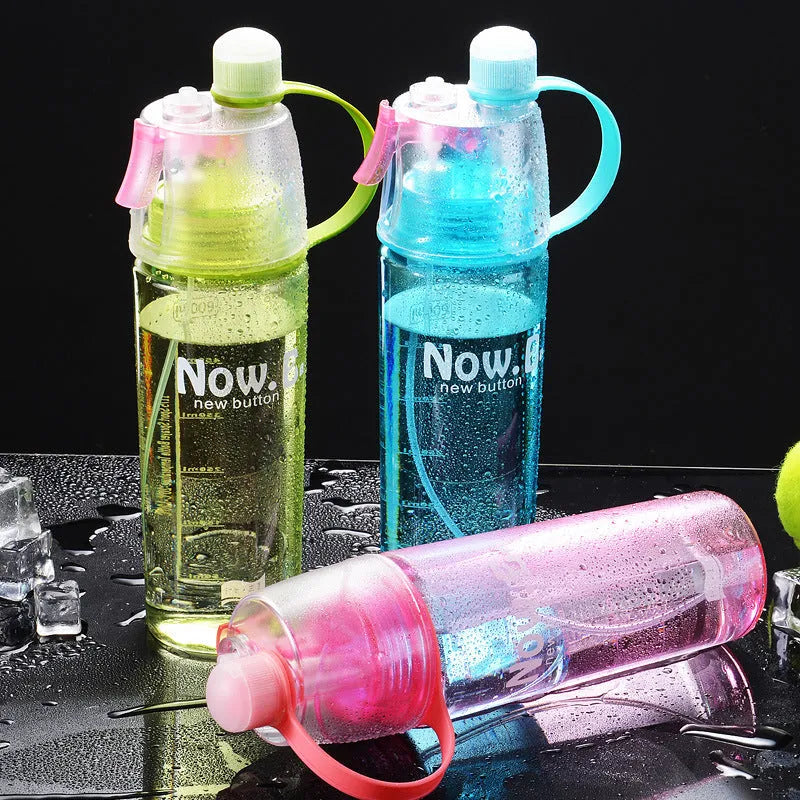 Green portable sports mist spray cup with transparent body, scale markings, and a black spray mouth cap.