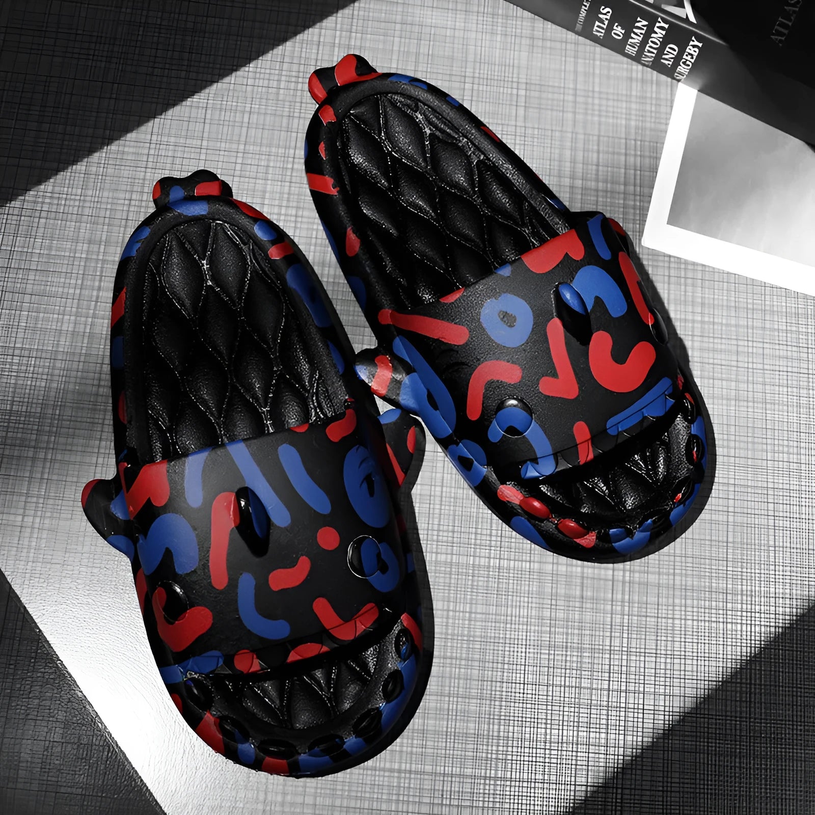 Pair of light beige shark-shaped EVA foam slippers for couples on a wooden floor