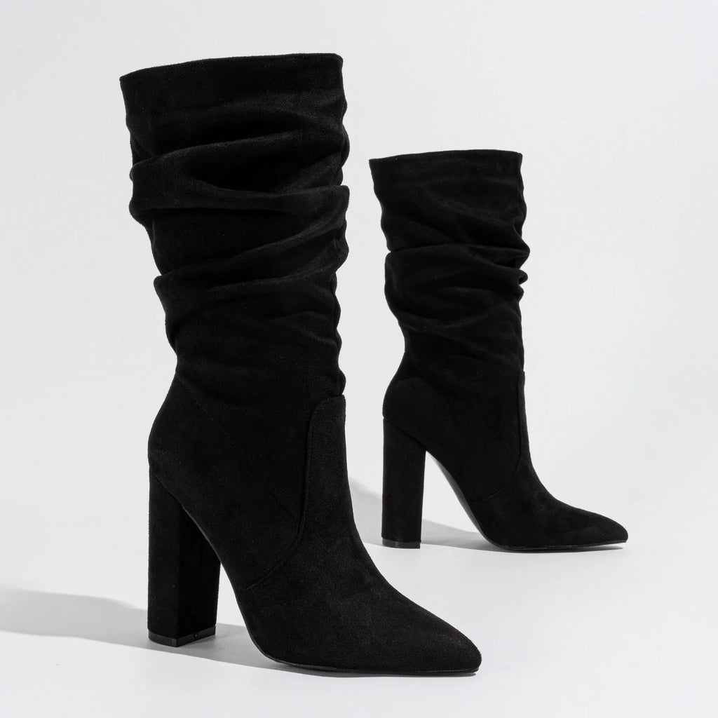 Women's black suede chunky heel pointed toe ankle boots with a high heel, shown from the side.