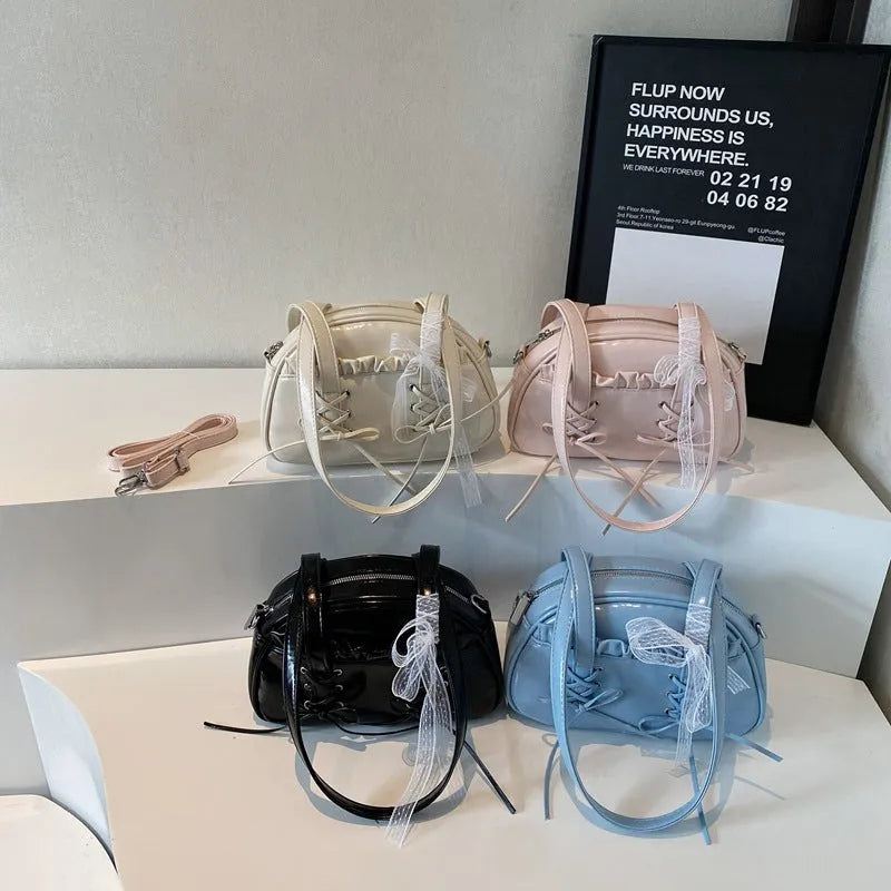 Women's casual PU leather shoulder bag with a bandage bow design and internal phone compartment.