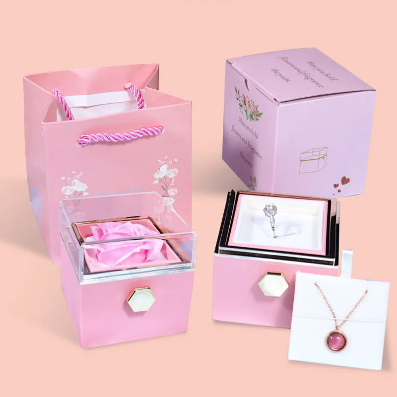 Rotating drawer jewellery gift box with red preserved rose under clear acrylic dome, showing open compartment.