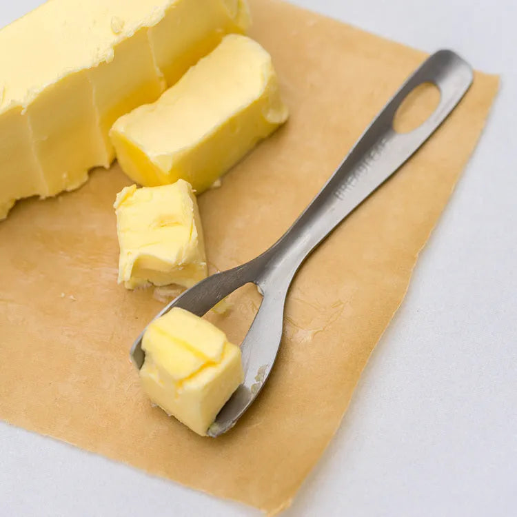 Stainless steel butter cutter with 12cm blade and sharp edge on a surface