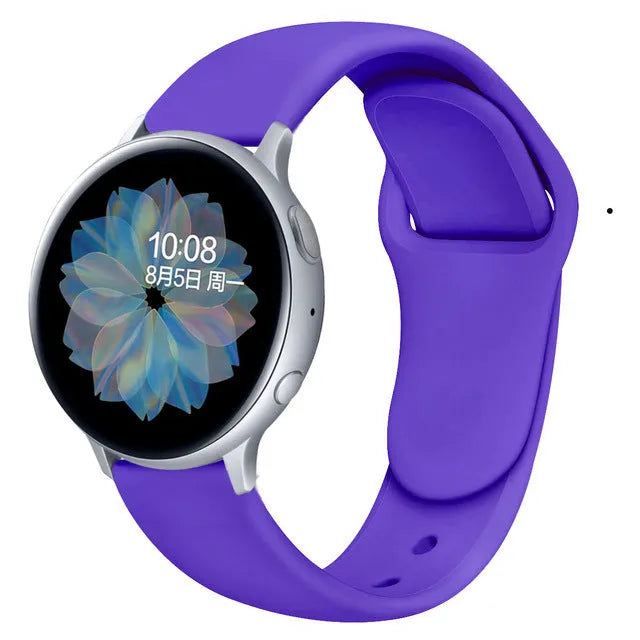 Samsung Galaxy Active 2 watch with a purple reverse buckle silicone strap on a wrist.