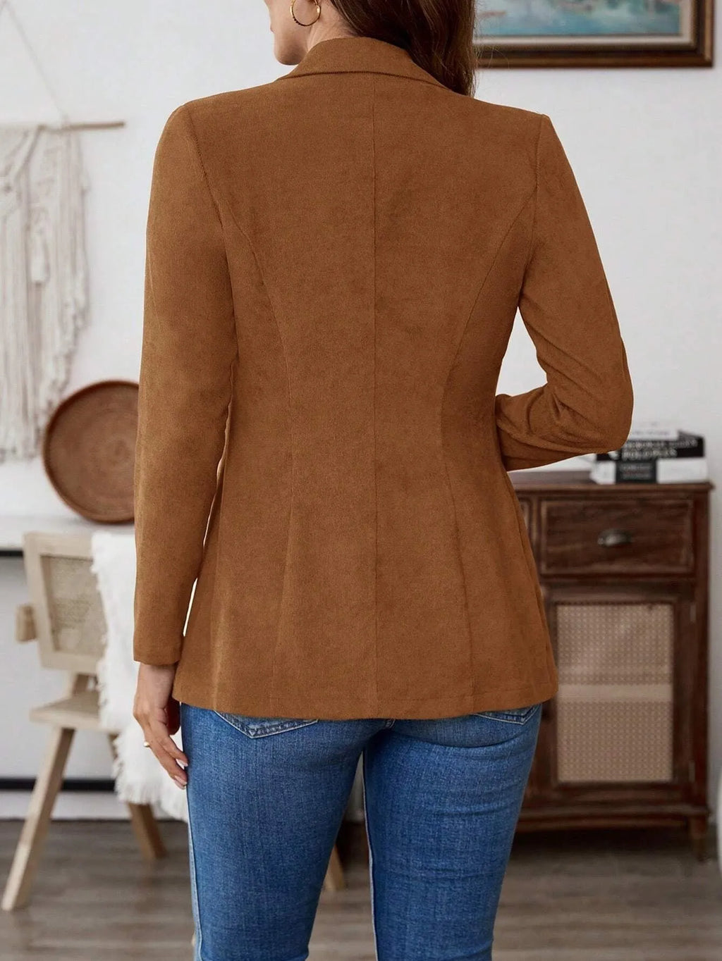 Brown men's single-breasted blazer with lapel collar and long sleeves on a hanger.