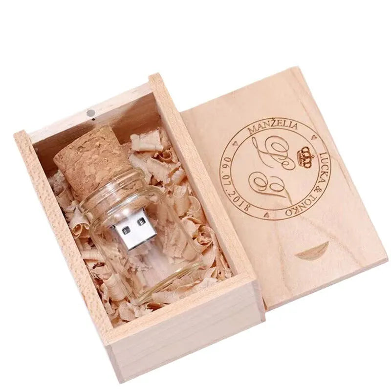 Wooden and transparent glass bottle-shaped USB flash drive on a wooden surface.