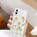 White iPhone case with a raised epoxy daisy floral design on the back.