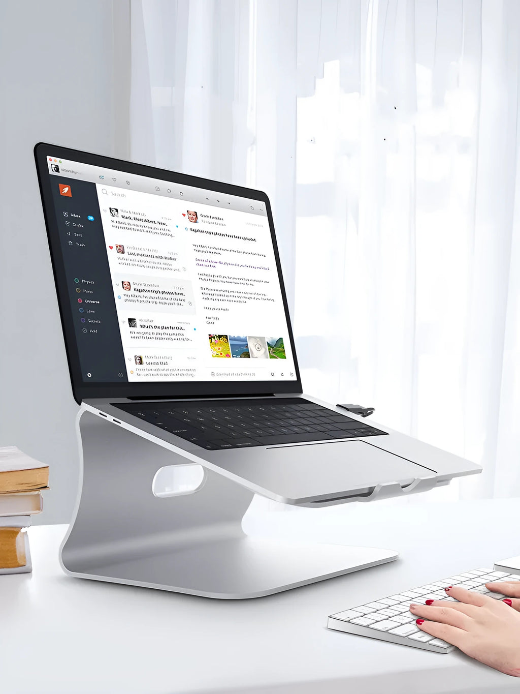 Grey aluminium laptop cooling stand with a thick 4.07mm frame and a rotating base on a wooden desk.