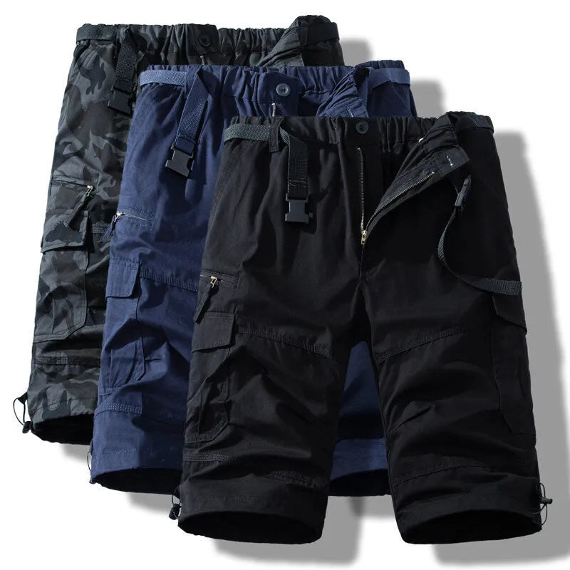 Men's cotton cropped overalls in army green, shown in a casual summer setting.