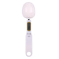 White digital spoon kitchen scale with LCD display showing weight measurement.