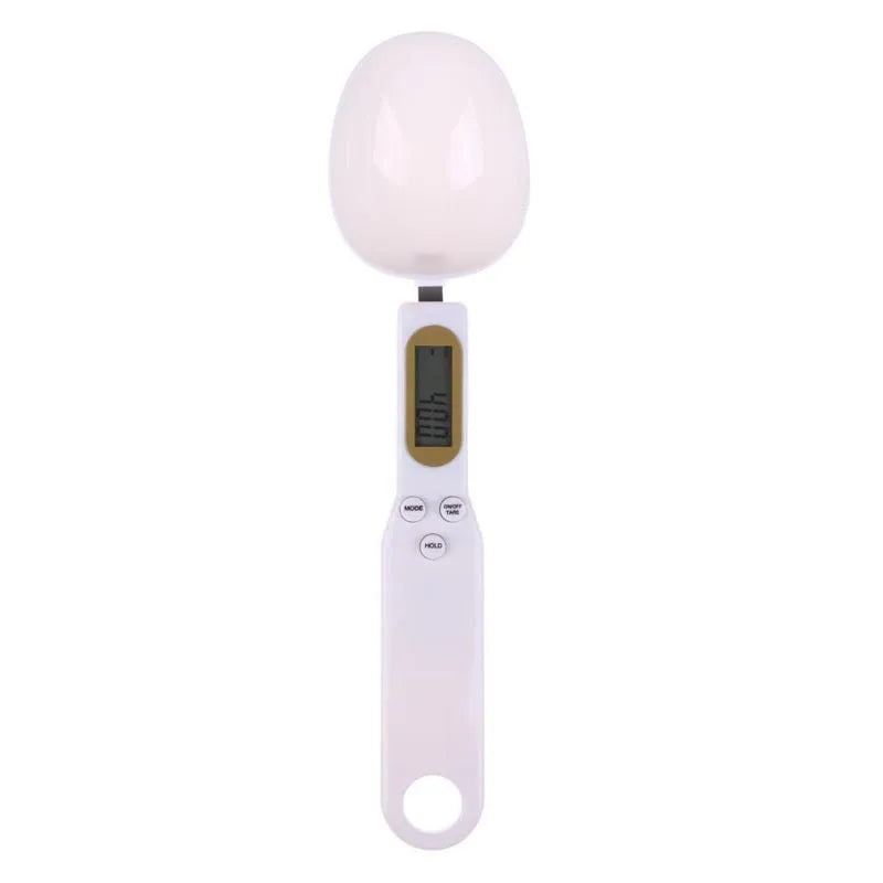 White digital spoon kitchen scale with LCD display showing weight measurement.