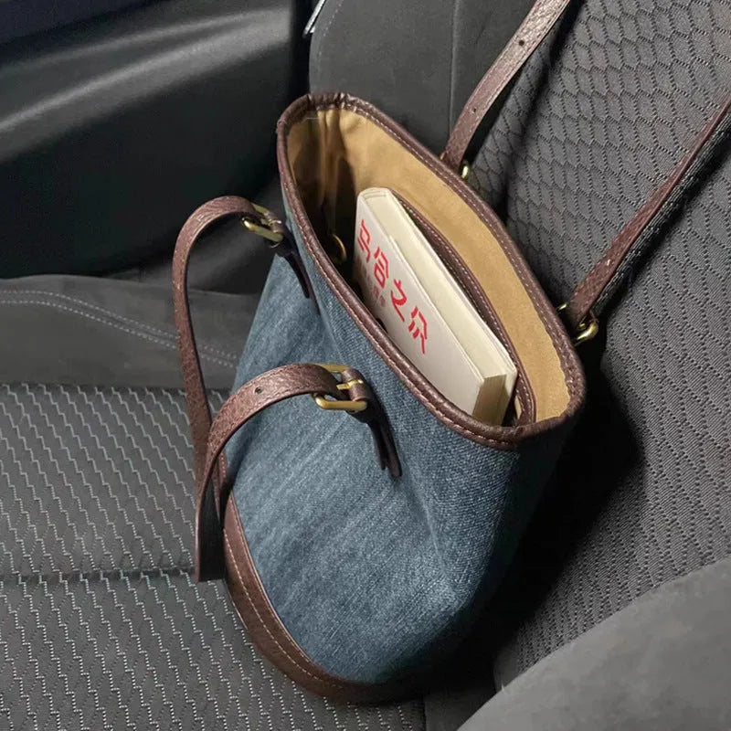 Retro blue denim patchwork one-shoulder bucket bag with large capacity.