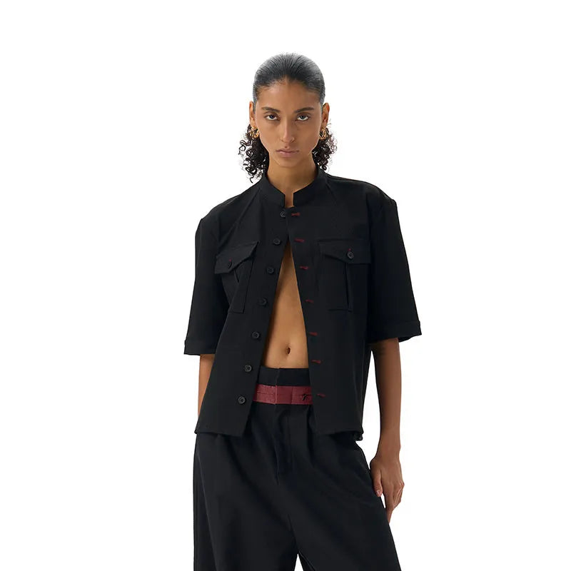 Handmade black loose-fit half sleeve hunting shirt with a shirt collar on a hanger.