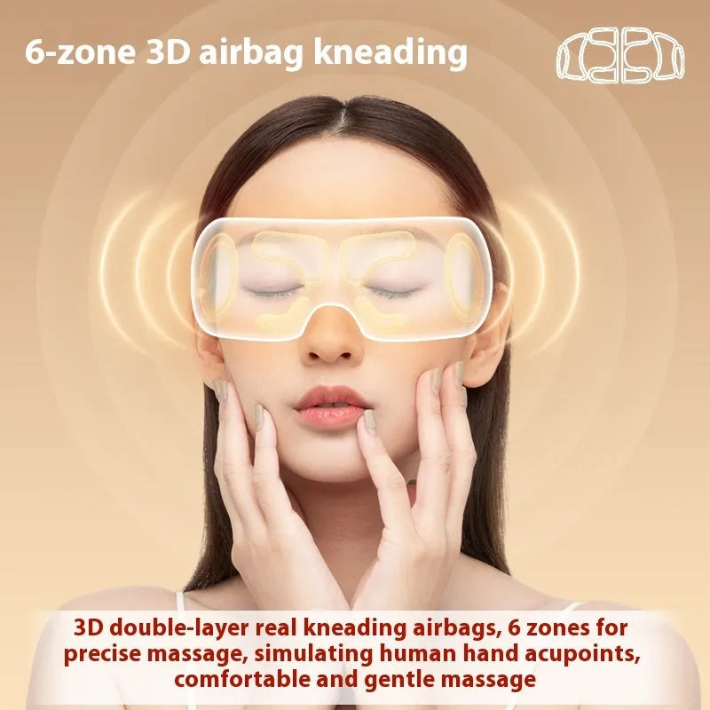 White rechargeable eye massager with hot compress and airbag massage functions on a table