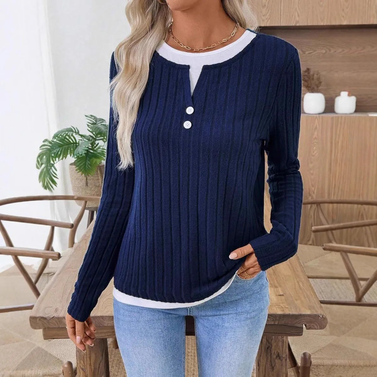 Women's black concave stripe fake two-piece pullover sweater with long sleeves and round neck.