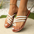 Women's white woven flat sandals with an adjustable strap over the instep and a flexible rubber sole.