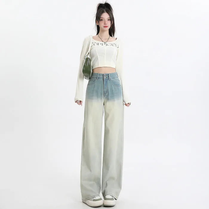 Women's gradient blue straight-leg denim trousers on a hanger, showing wide-leg silhouette.