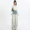 Women's gradient blue straight-leg denim trousers on a hanger, showing wide-leg silhouette.