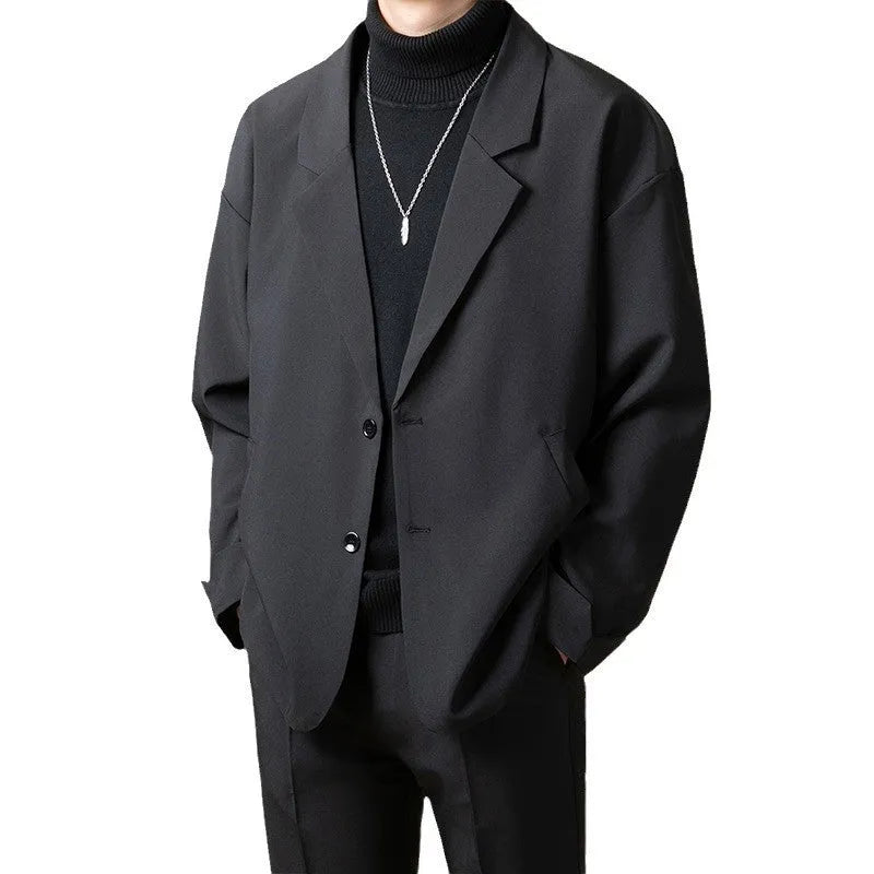 Man wearing a loose-fit casual suit jacket in a light business style, available in multiple colours.