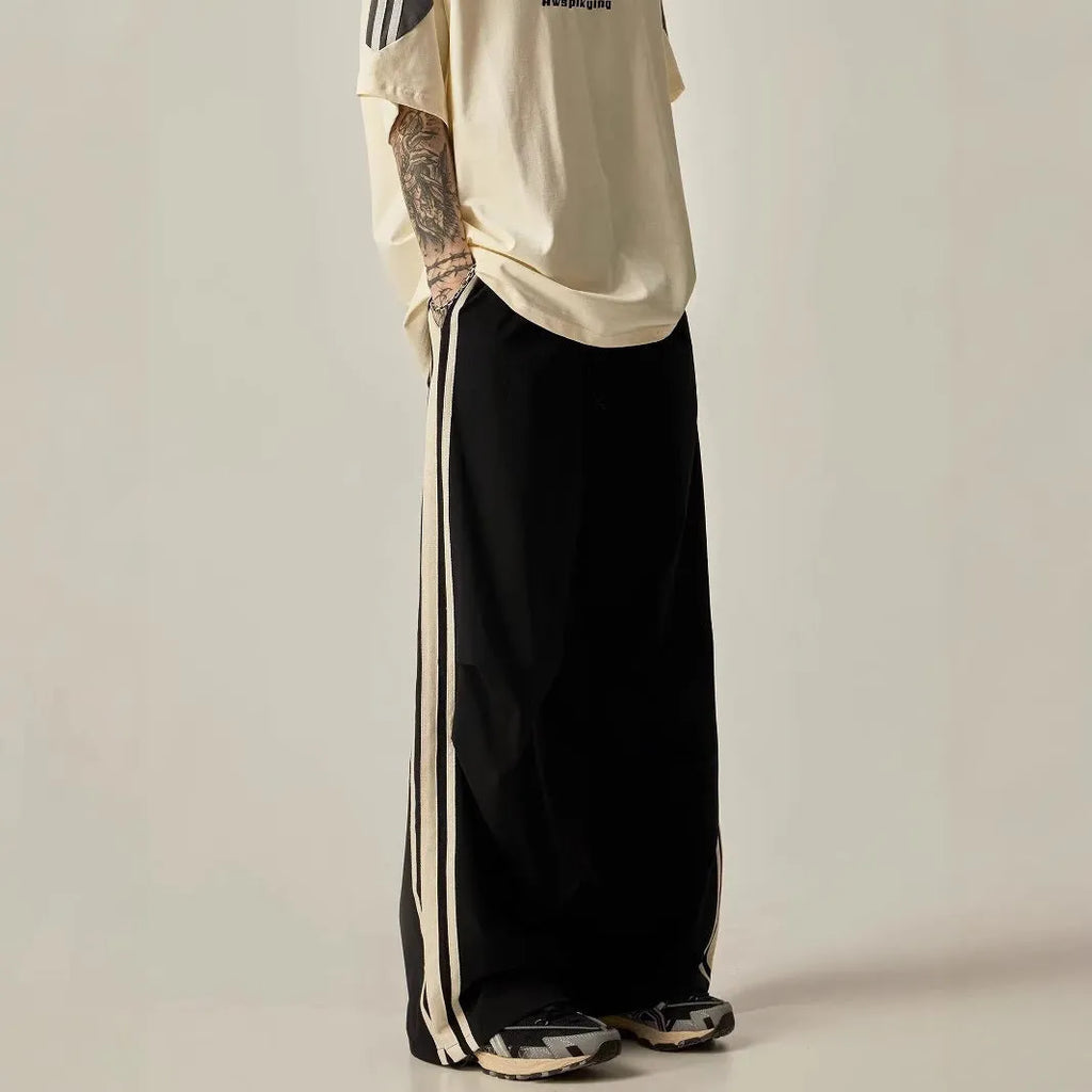Black men's high-waist wide-leg climbing trousers laid flat, showing straight-leg design.