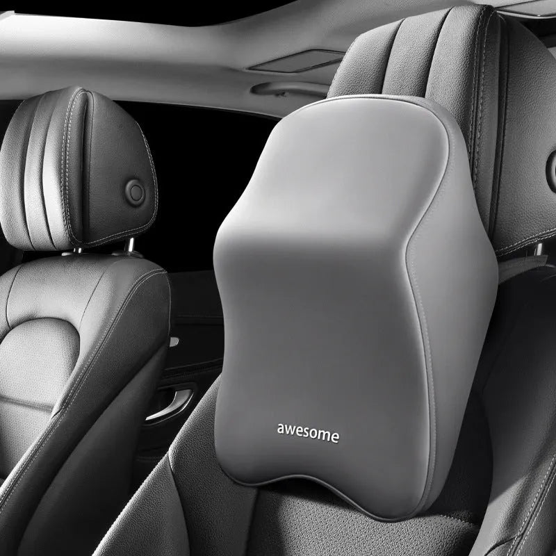 Black geometric pattern memory foam car lumbar pillow and matching headrest on a car seat.