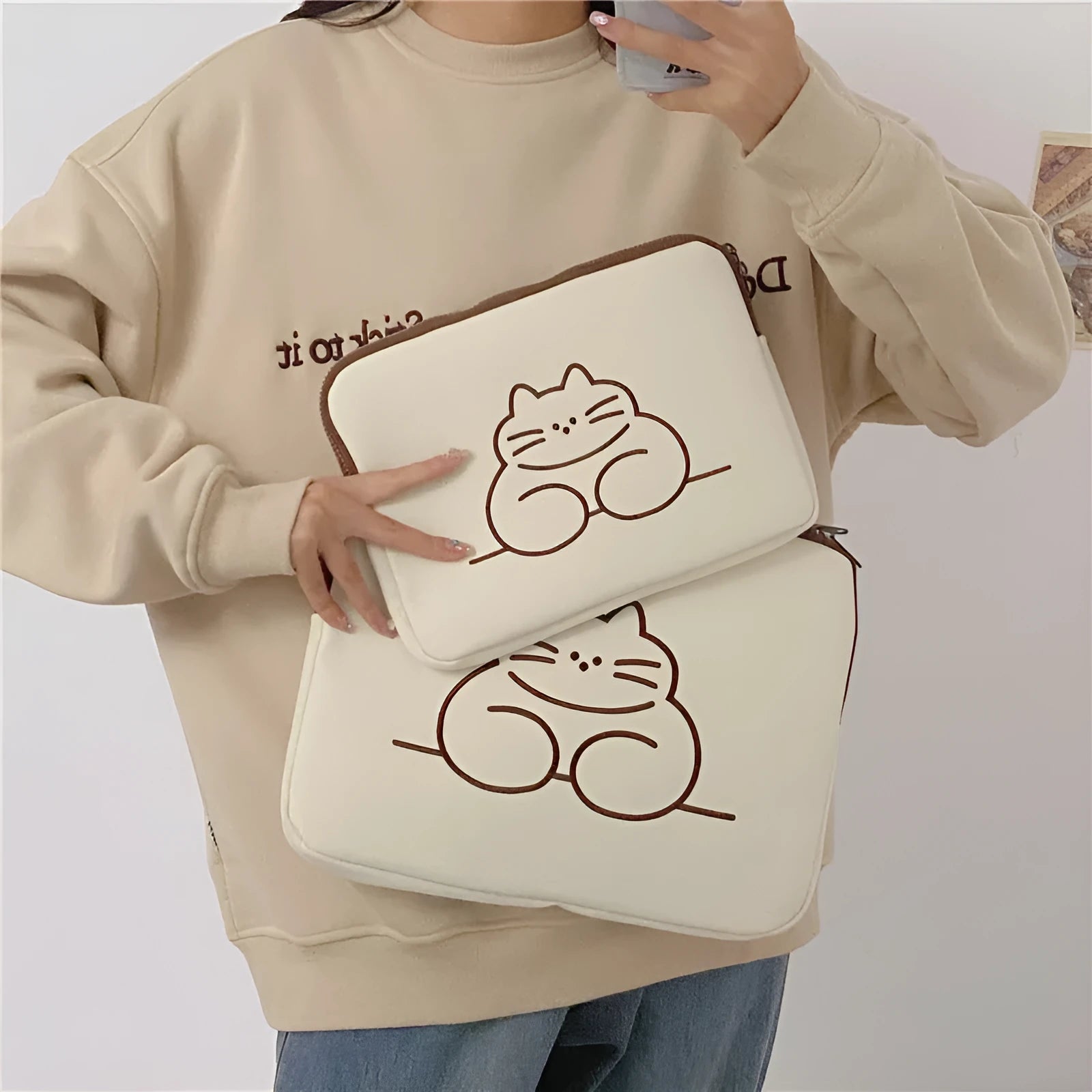 Fat cat embroidered protective sleeve for tablets, showing front zipper pocket and padded interior.