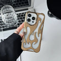 Electroplated hollow flame pattern iPhone case in silver, showing detailed cut-outs and metallic finish on a phone.
