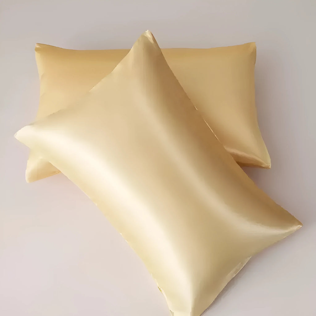 A pair of solid colour satin pillowcases made from polyester fibre, shown in one of 13 available colours.