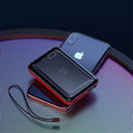 Small square black portable power bank with wireless charging surface and digital LED display.