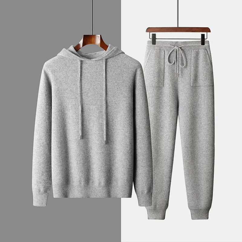 Men's light grey cashmere hooded sweatshirt and matching trousers set laid flat.