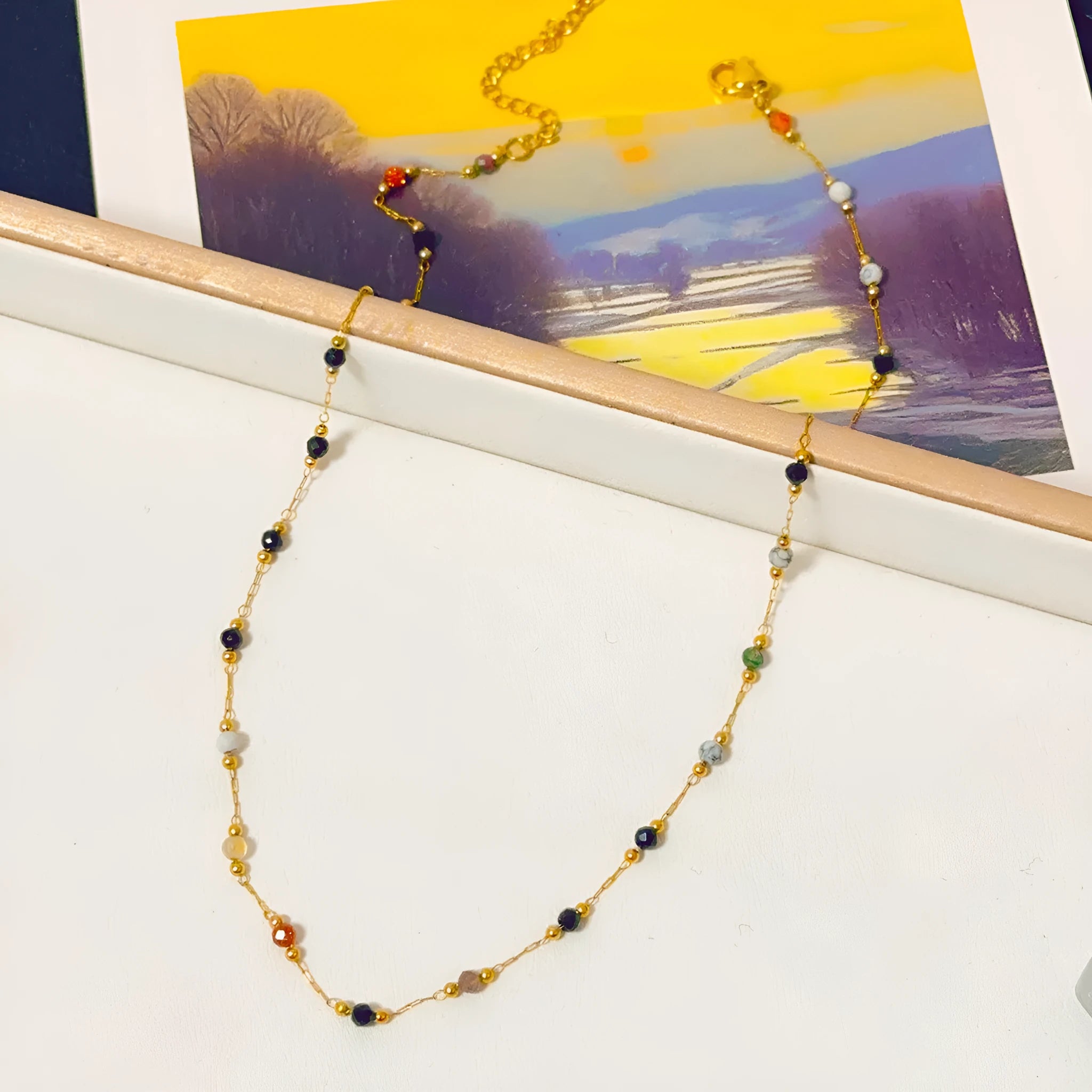 Gold titanium steel women's necklace with natural stone pendant on O-ring chain.